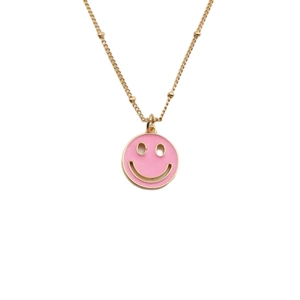 Golden necklace featuring a pink enamel smiley face pendant with sparkling zircon accents