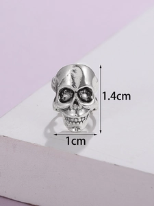 Macro view of gothic skull earring showing 1.4cm by 1cm dimensions in antique silver
