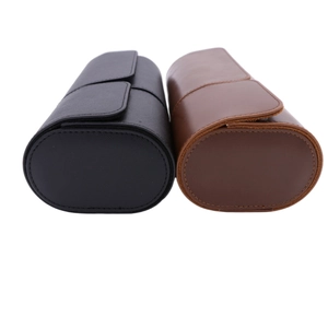 Detail view of cylindrical PU leather watch storage cases in black and brown colors