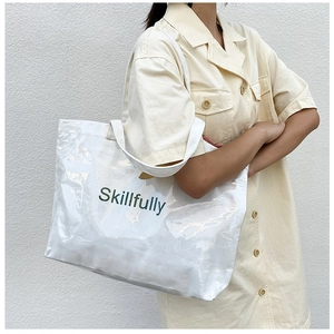 Detail of clear PVC tote with Skillfully print and white canvas inner lining bag