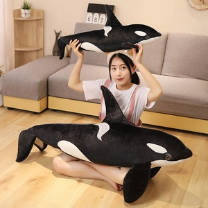 Detailed comparison of large and medium plush orca whale toys with soft black and white fur