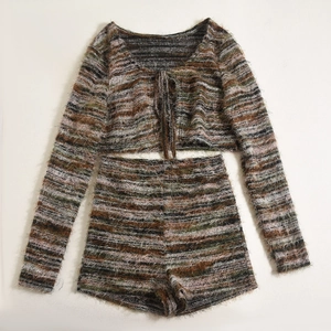 Detail of a two-piece knit set featuring a striped long sleeve wrap top and high waist shorts