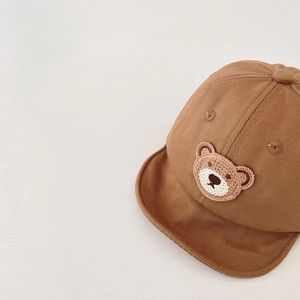 Detailed view of baby cotton baseball cap featuring soft brim and knitted bear patch
