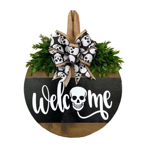 Halloween wooden door sign featuring black welcome banner with skull and burlap bow