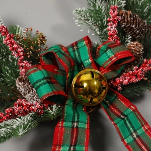 Christmas pinecone wreath with red-green plaid bow, golden bells, and berries on grey back