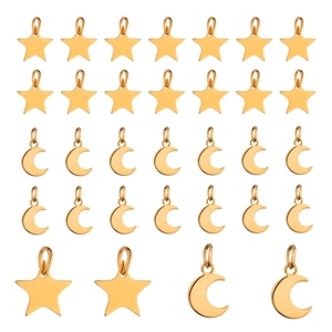 Macro shot of gold stainless steel star and moon charms for DIY jewelry making