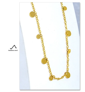 Close-up detail of gold stainless steel choker necklace with small circular disk pendants
