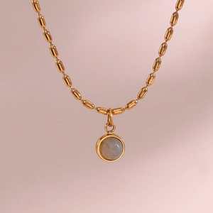 Macro view of 18K gold-plated chain featuring a mini moonstone pendant detail