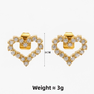 Detail of 1cm golden heart stud earrings with white zircon inlay on white background