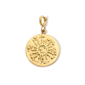 Macro detail of golden circular sun and star relief pendant with a spring clasp