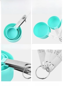 Detail of mint green measuring cups with stainless steel handles and engraved markings