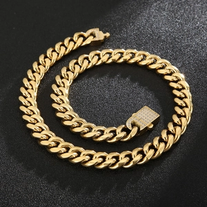 Detailed view of gold Cuban link chain with a sparkling diamond-encrusted square clasp