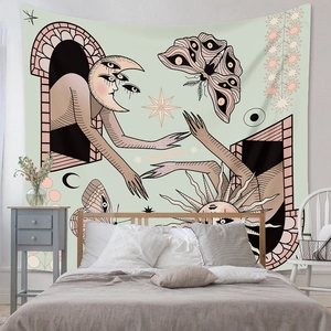 Bedroom wall decor detail showing mystical sun and moon moth tapestry over a bed