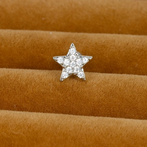 Macro shot of silver star stud earring with shimmering pave-set cubic zirconia detail
