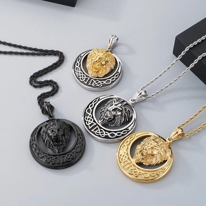 Detail of four hip-hop lion head pendants in gold, silver, and black stainless steel