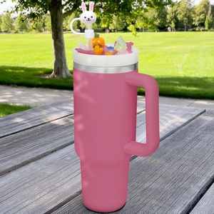 Close-up of pink travel mug with cute resin animal decorations and rabbit straw topper