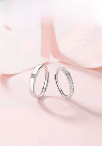 Detail of S925 sterling silver couple rings showing the S925 stamp and adjustable bands
