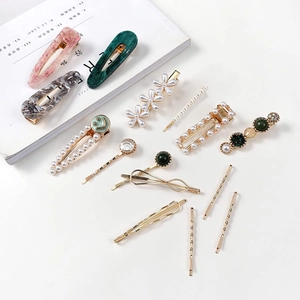 Flat lay of 12pcs marble and pearl hair clip set with resin clips and gold bobby pins