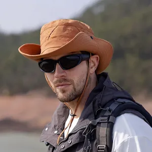 Brown wide-brim sun hat for outdoor hiking with adjustable strap and foldable brim design