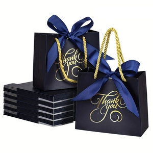 Detail of dark blue gift bags with gold Thank You text and elegant ribbon bow