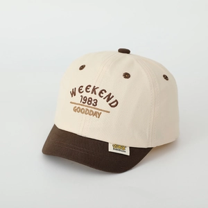 Detailed embroidery of 'WEEKEND' on kids' color-block cotton baseball cap with short brim