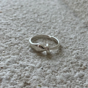 Macro shot of minimalist 925 sterling silver ring with organic curved design