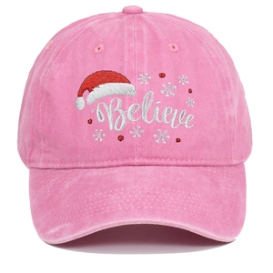 Detail of pink washed baseball cap featuring Believe text and snowflake embroidery