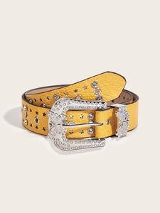 Detail of yellow crocodile pattern leather belt with rhinestone butterfly buckle and star studs
