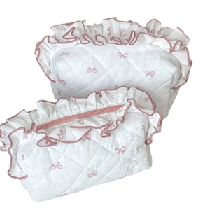 Quilted cotton cosmetic bag set with pink bow print and ruffle trim in two sizes