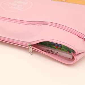 Close-up of smooth pink zipper and canvas texture on waterproof A4 document storage bag