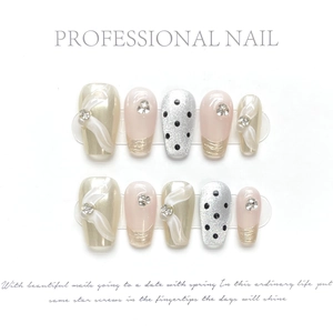 Polka dot press-on nails set with champagne gold, 3D ribbon, and rhinestone accents