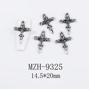 Macro detail of gothic antique silver cross skull charms for 3D nail art decoration