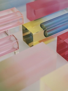 Artistic layout of colorful geometric acrylic blocks with transparent gradient finish