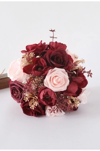 Detailed close-up of bridal bouquet with deep red roses, peonies and golden berries