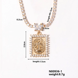 Macro detail of gold religious square pendant necklace with dimensions and white zircons