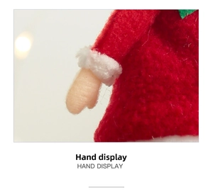 Close-up of the plush Christmas elf doll's red sleeve and hand-stitched details