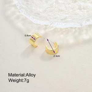 Detail view of gold drop earrings showing 2.3cm diameter and 0.8cm width measurements