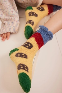 Detail of coral fleece crew socks with house pattern and fluffy cloud decoration