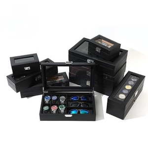 Detail of black leather watch box with transparent glass window and metal lock