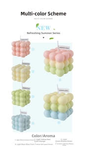 Detailed view of colorful cube bubble candles with handmade labels and soft pastel tones