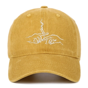 Detail of embroidered mustard yellow washed cotton baseball cap with retro graphic
