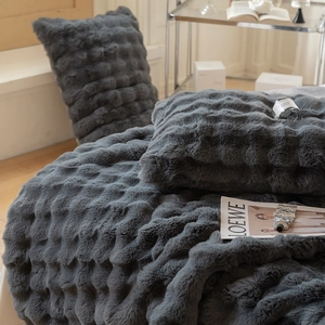Macro detail of dark grey faux fur blanket with high-end wavy 3D textured embossing