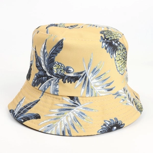 Close-up of tropical pineapple and palm leaf print on yellow cotton bucket hat