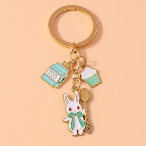 Detail of creative metal keychain featuring a white rabbit, milk box, and spoon charm