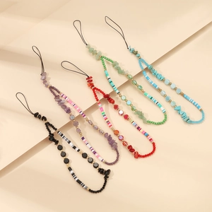 Macro view of five colorful beaded phone straps with natural stones and acrylic charms