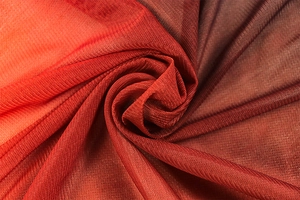 Detail of breathable red orange gradient mesh fabric with pleated texture and soft drape