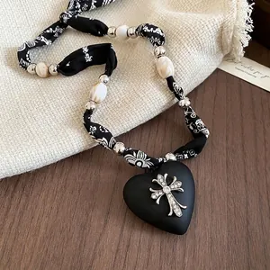 Retro leopard heart cross pendant necklace with black matte finish and patterned fabric cord
