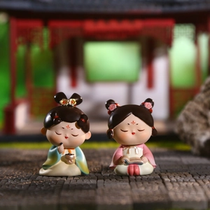 Pair of resin Tang dynasty bobblehead girl figures in traditional Chinese attire on courtyard