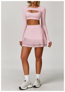 Close-up of pink long-sleeve crop top with front cutout and pleated mini skirt set