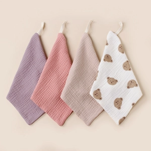 Detail of 4-pack muslin baby washcloths with bear print and hanging loops in soft cotton